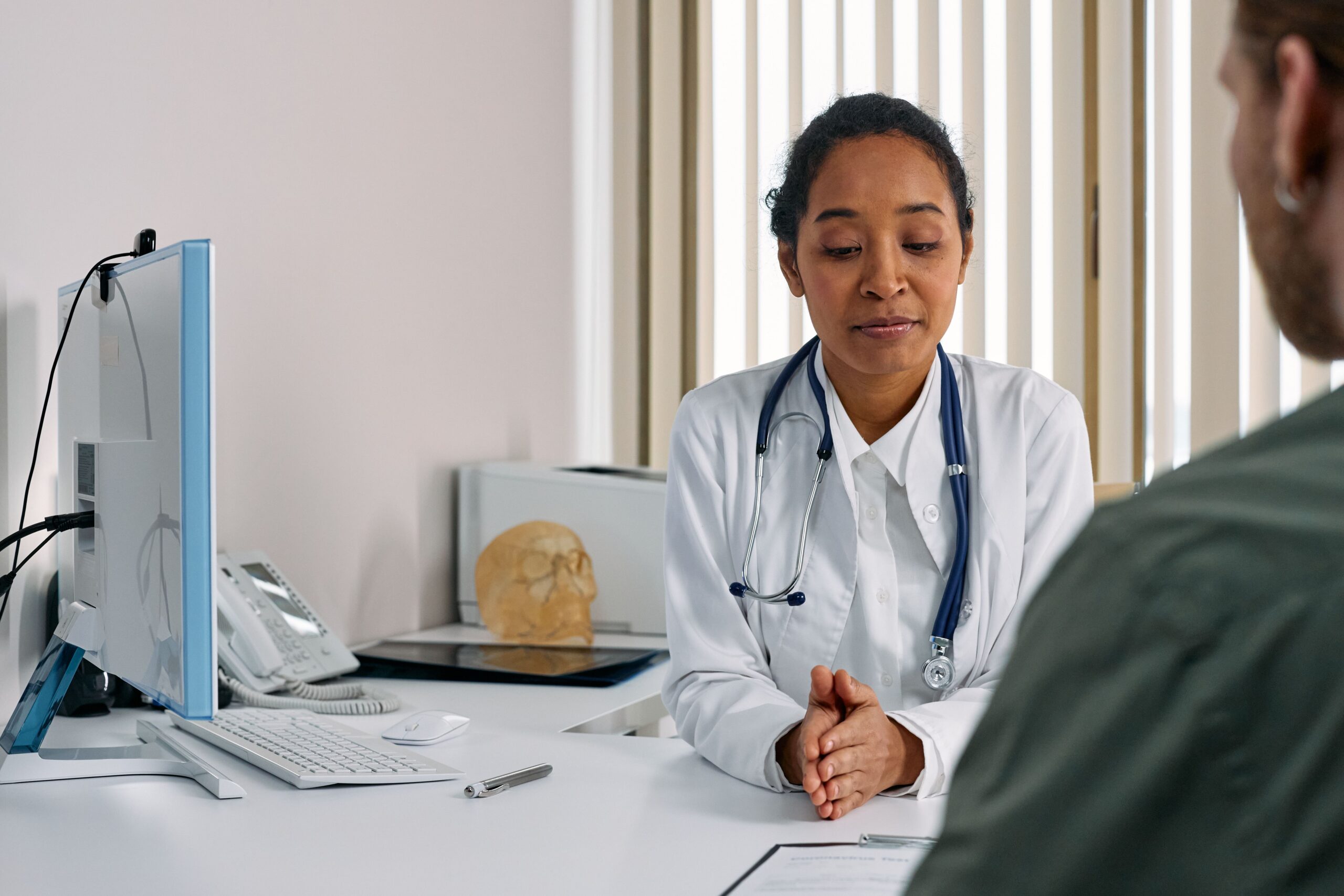 A Primary care doctor talking with patient about their health in Akron.
